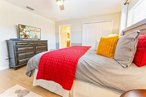 a bedroom with a bed and a painting on the wall