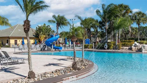 a view of a swimming pool with seating space