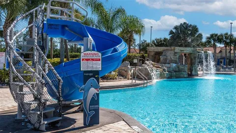 a palm tree sitting in front of a house with palm trees