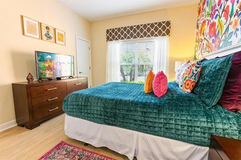 a bed sitting in a bedroom next to a window