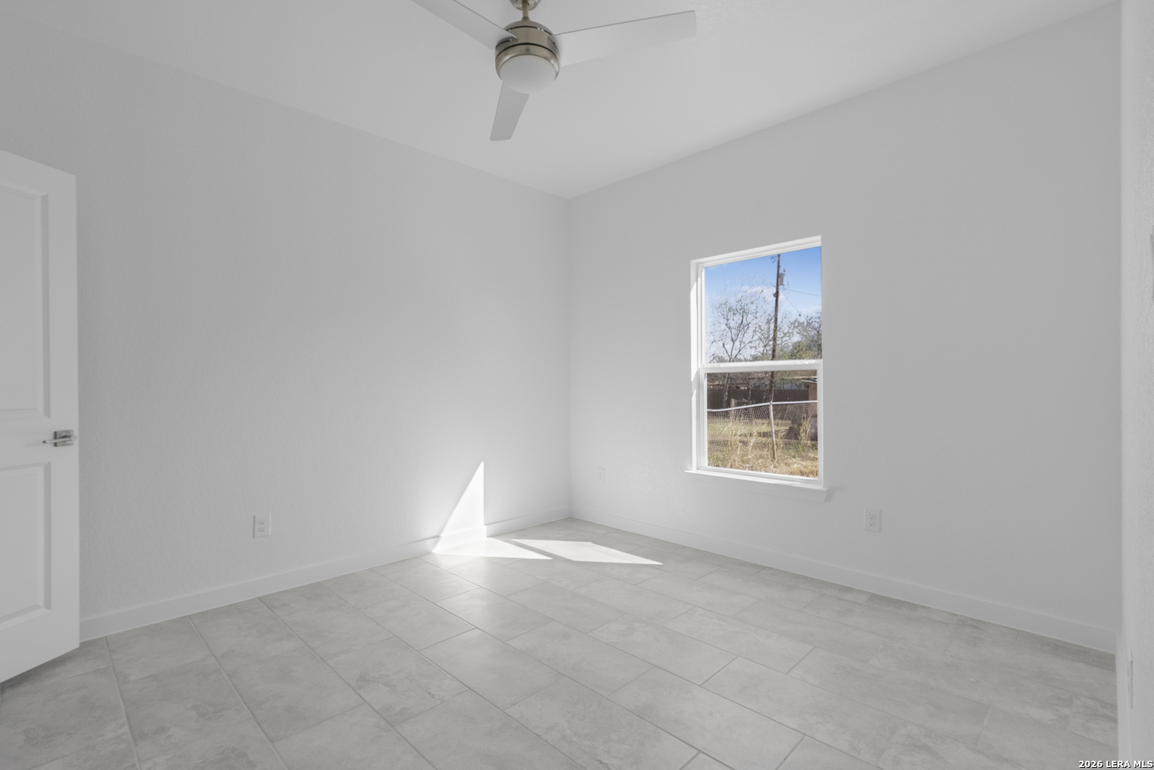 804 Peach Street Jourdanton, TX 78026 - Photo 12 of 16 a view of an empty room with a window