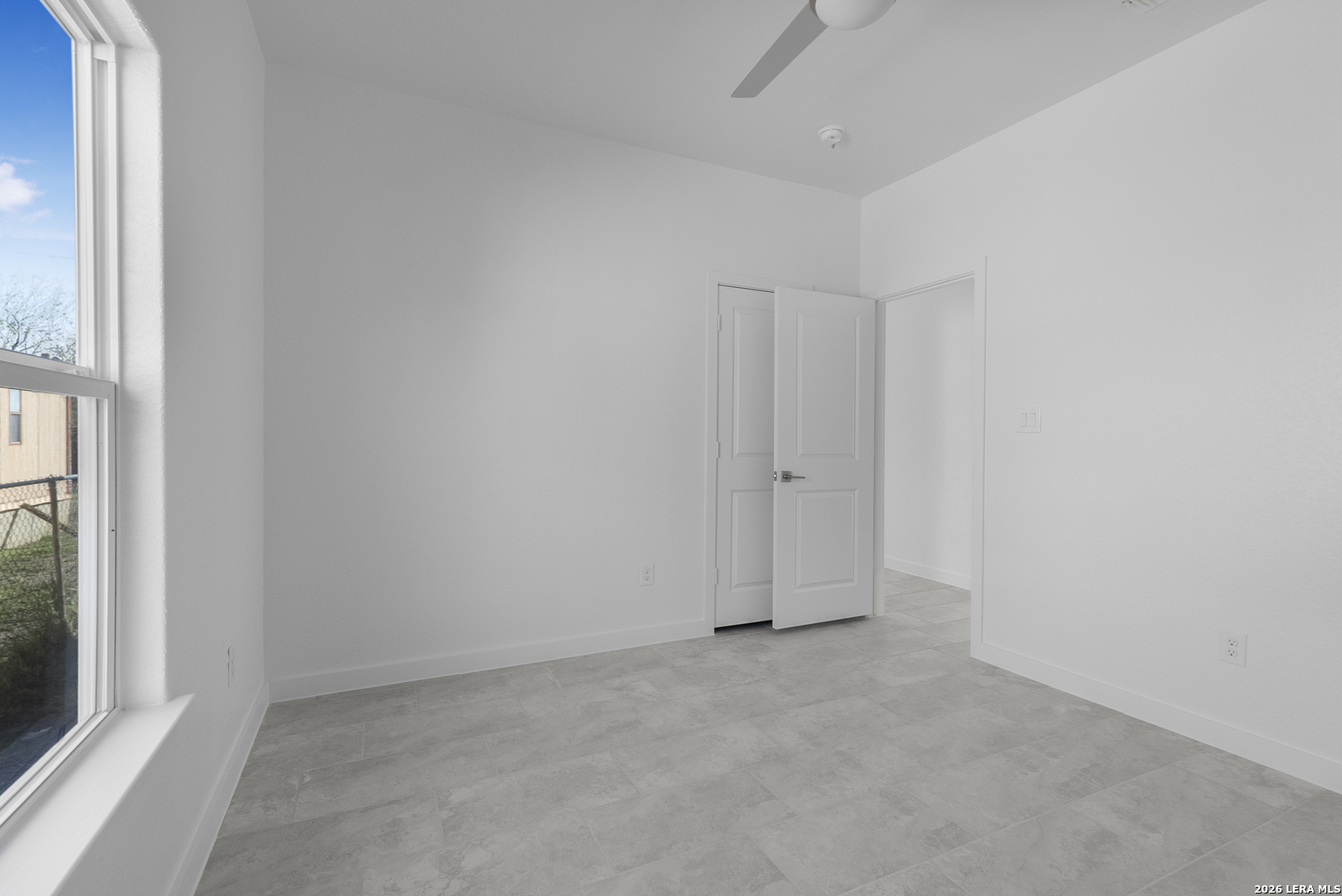 804 Peach Street Jourdanton, TX 78026 - Photo 13 of 16 wooden floor in an empty room with a window