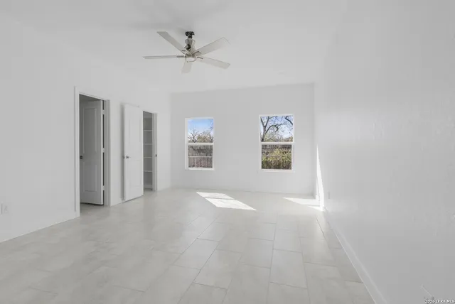 a bathroom with a granite countertop toilet a sink and bathtub
