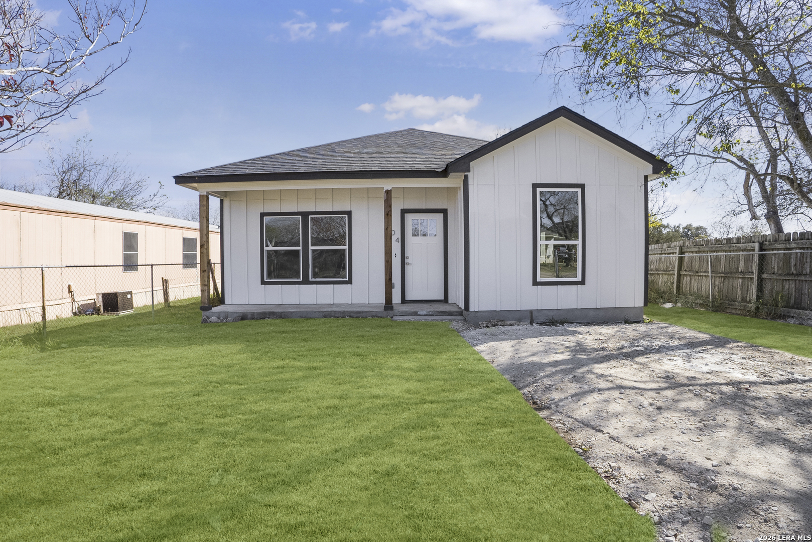 804 Peach Street Jourdanton, TX 78026 - Photo 2 of 16 a view of a house with a yard and potted plants