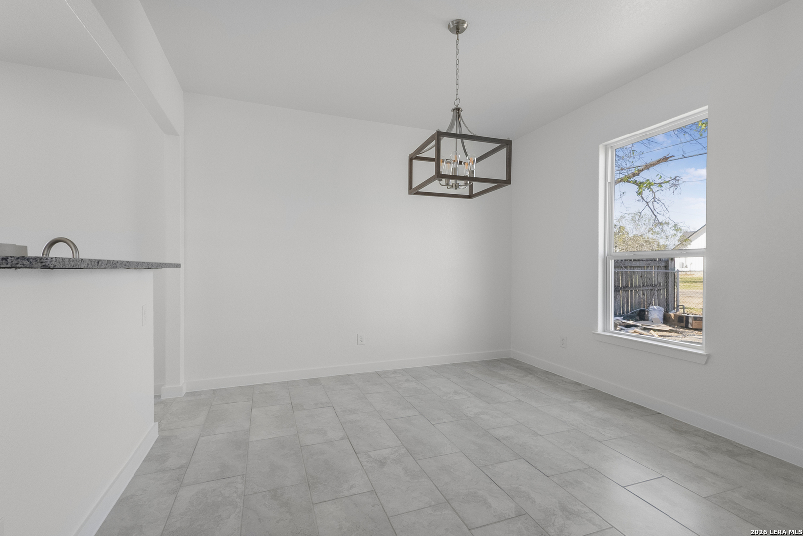804 Peach Street Jourdanton, TX 78026 - Photo 5 of 16 a view of an empty room with a window