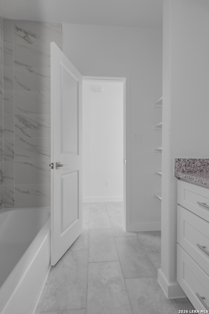 804 Peach Street Jourdanton, TX 78026 - Photo 10 of 16 a bathroom with a bathtub