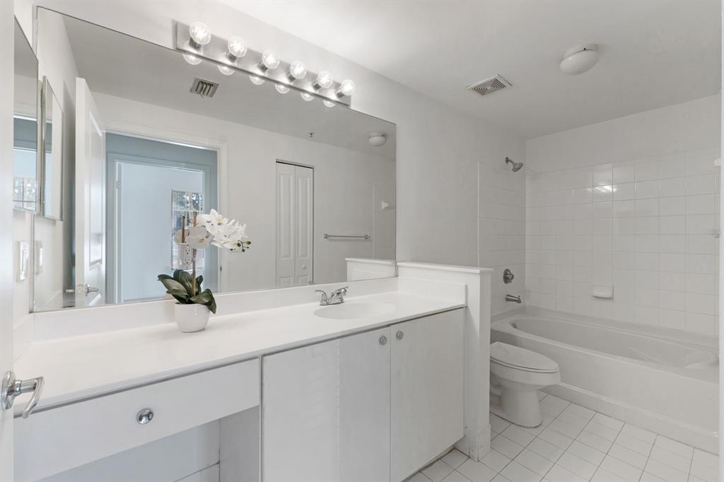 5800 West Sample Road, Unit 102 Coral Springs, FL 33067 - Photo 16 of 23 a bathroom with a double vanity sink mirror and toilet