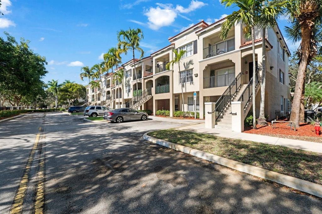 5800 West Sample Road, Unit 102 Coral Springs, FL 33067 - Photo 21 of 23 a view of a building with a street