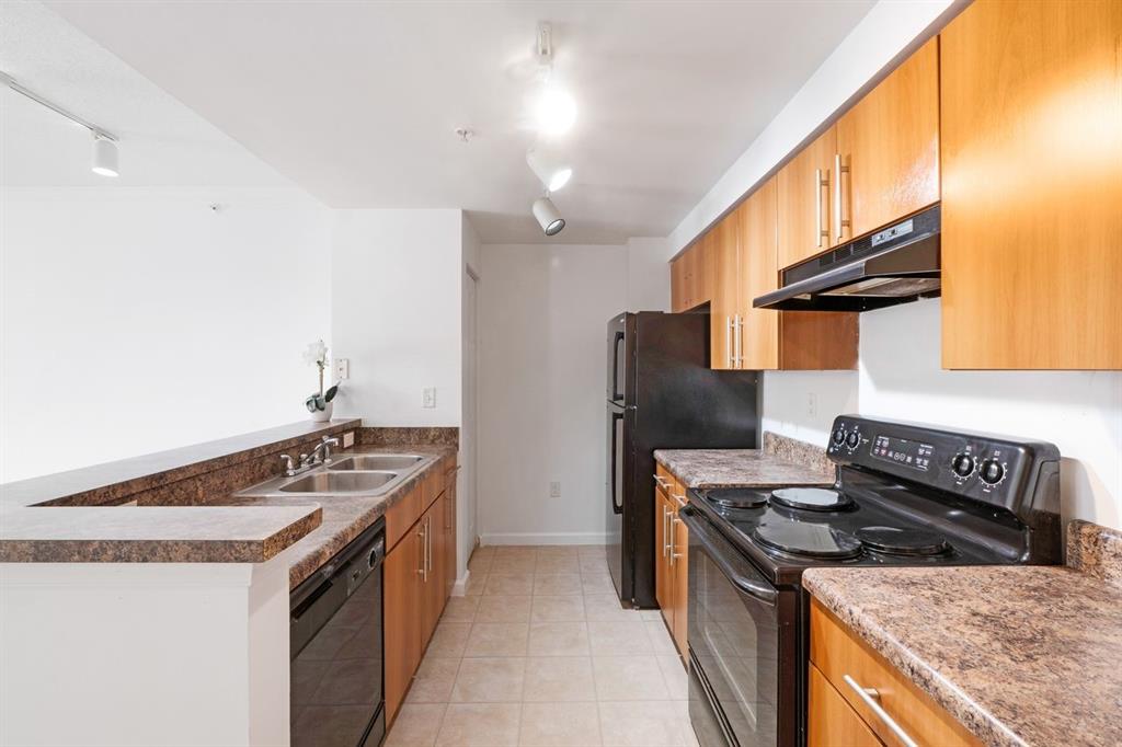 5800 West Sample Road, Unit 102 Coral Springs, FL 33067 - Photo 8 of 23 a kitchen with stainless steel appliances granite countertop a stove and a cabinets