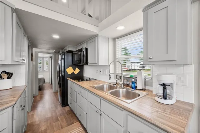 a kitchen with a sink stove and wooden cabinets