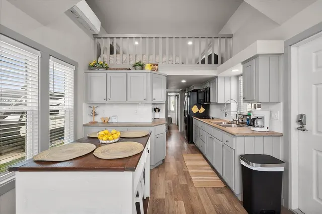a kitchen with a sink cabinets and wooden floor