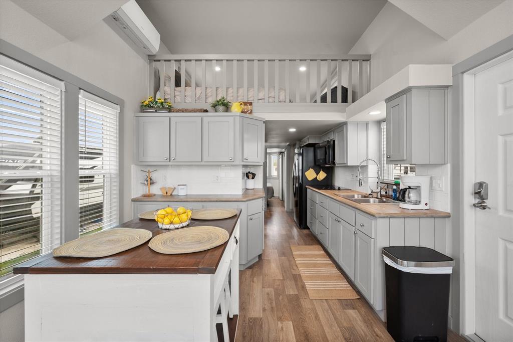 6388 Peninsula Road Kerens, TX 75144 - Photo 12 of 38 a kitchen with a sink stove and wooden cabinets