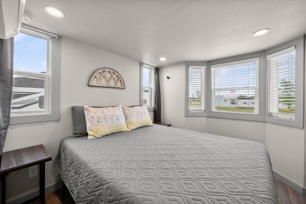 6388 Peninsula Road Kerens, TX 75144 - Photo 14 of 38 a bedroom with a large bed and a window