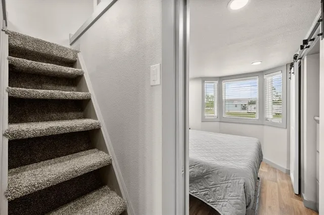 a bed room with a bed and a large window