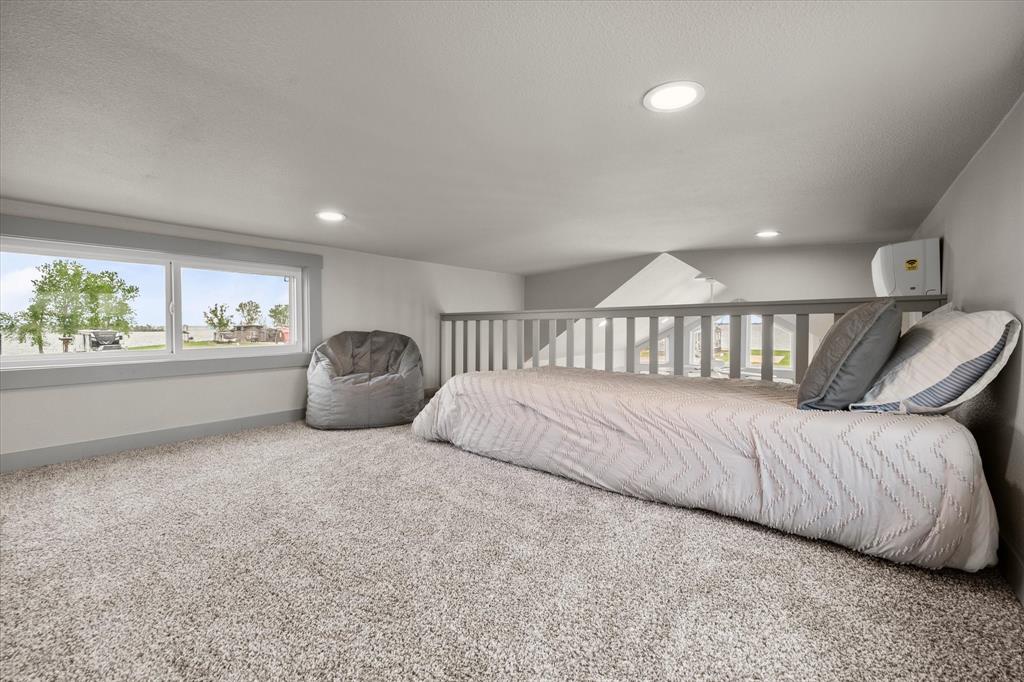 6388 Peninsula Road Kerens, TX 75144 - Photo 19 of 38 a bed room with a bed and a large window