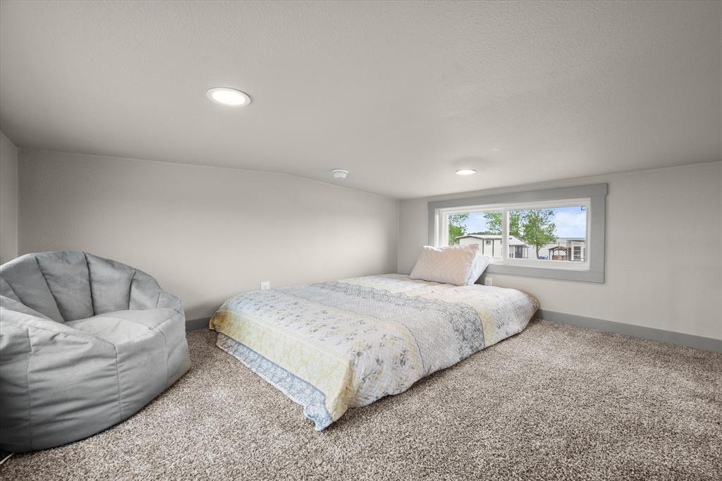 6388 Peninsula Road Kerens, TX 75144 - Photo 20 of 38 a bedroom with a bed and a couch