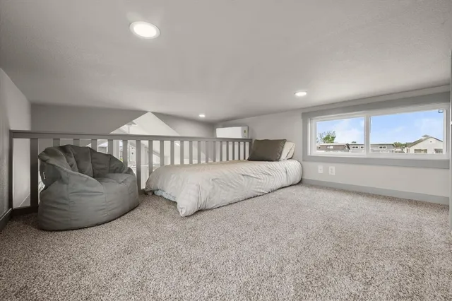 a bedroom with bed and window