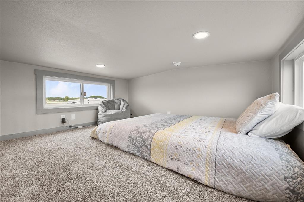 6388 Peninsula Road Kerens, TX 75144 - Photo 22 of 38 a bedroom with bed and window