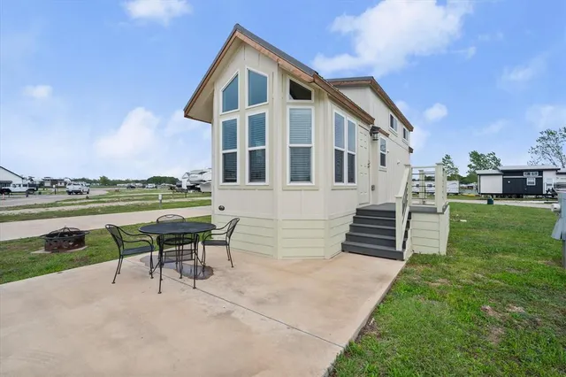 a front view of a house with a yard table and chairs