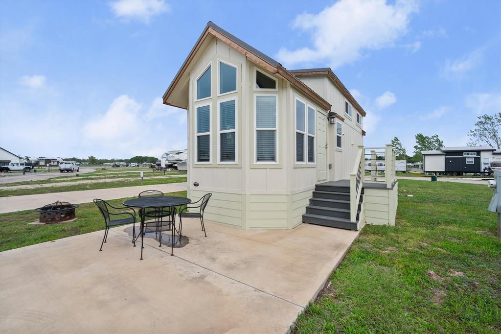 6388 Peninsula Road Kerens, TX 75144 - Photo 3 of 38 a front view of a house with a yard table and chairs