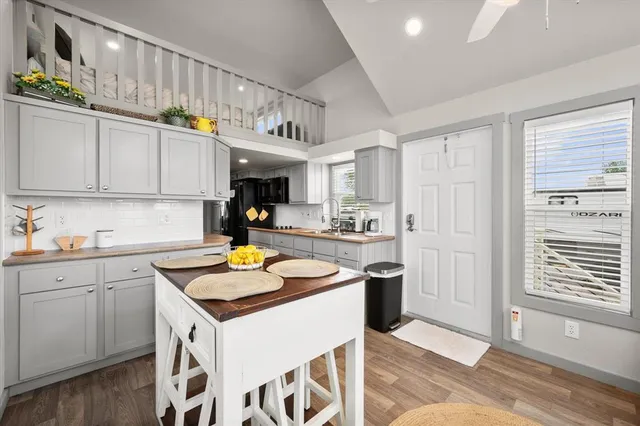 a kitchen with stainless steel appliances granite countertop a sink and cabinets