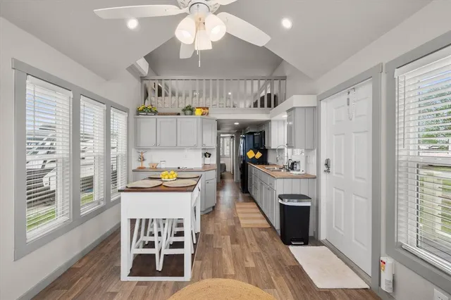 a kitchen with stainless steel appliances kitchen island granite countertop a stove and a refrigerator