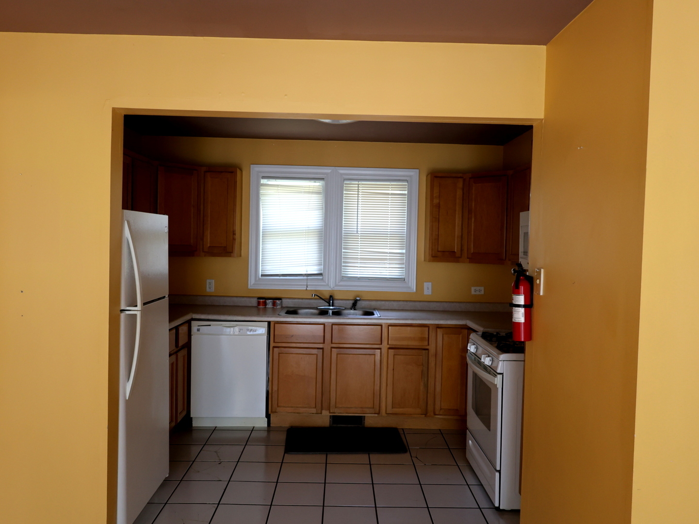 2911 Emmaus Avenue Zion, IL 60099 - Photo 10 of 28 a kitchen with a sink a refrigerator and cabinets