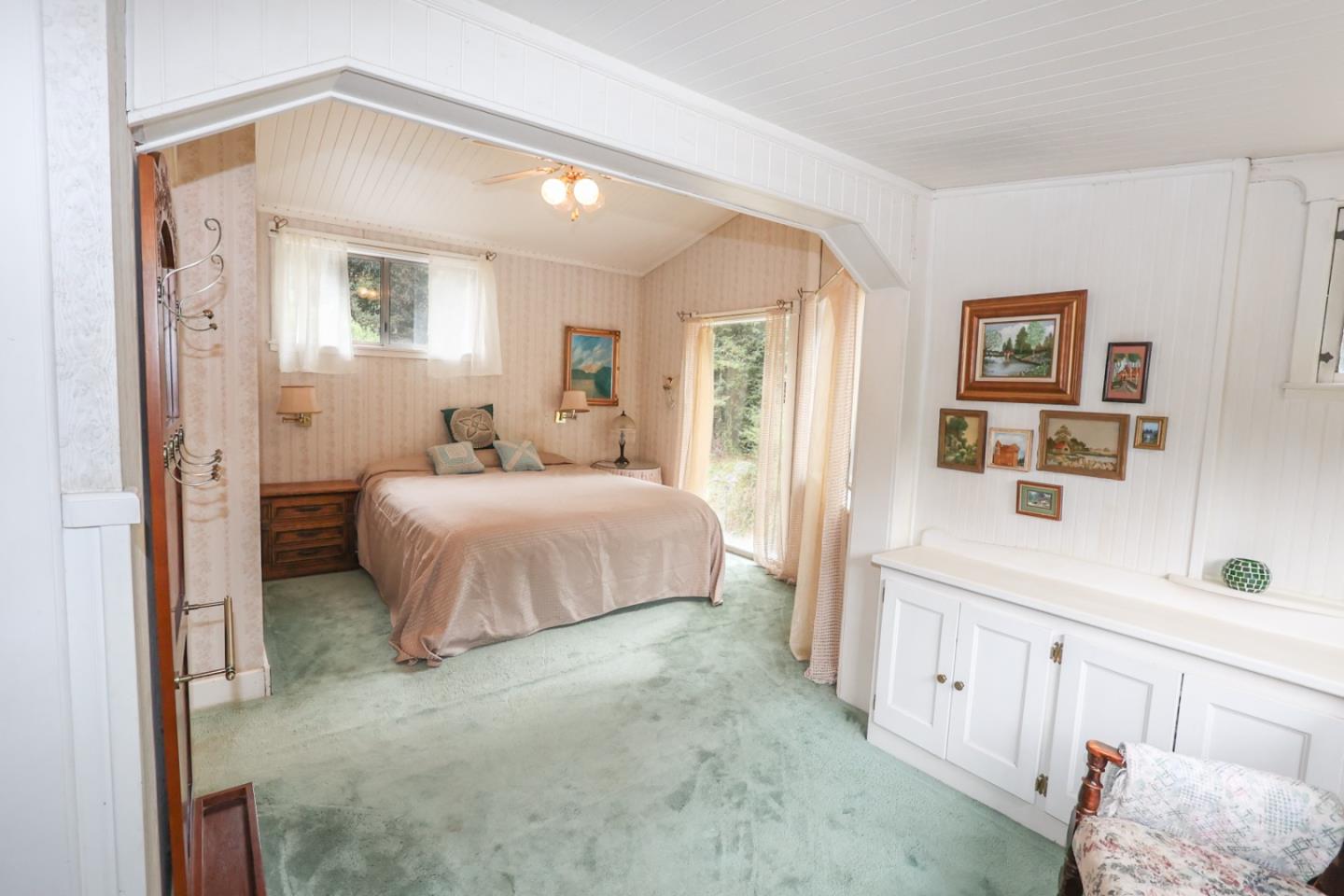 2007 Green Valley Road Watsonville, CA 95076 - Photo 22 of 52 a bedroom with a bed and a chandelier