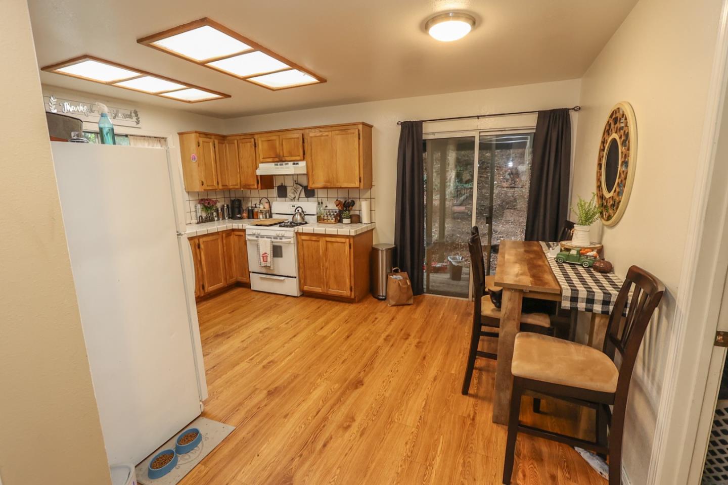 2007 Green Valley Road Watsonville, CA 95076 - Photo 45 of 52 a kitchen with a table chairs refrigerator and wooden floor