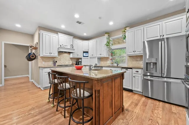 a kitchen with stainless steel appliances granite countertop a stove and a sink