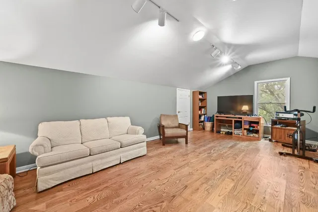 a spacious bedroom with a large bed and a large window