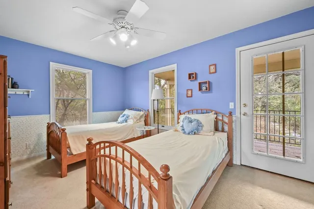 a bedroom with two beds and a chandelier