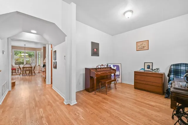 a view of a a dining room with furniture window and wooden floor