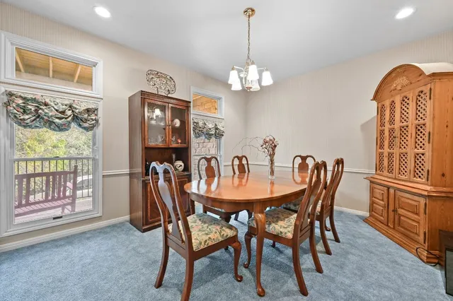 a living room with furniture a fireplace and a large window