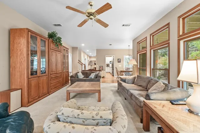 a dining room with furniture a chandelier and wooden floor