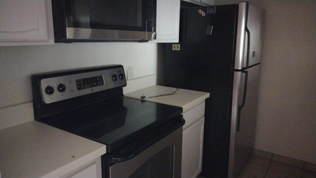4563 North O'Connor Road, Unit 2298 Irving, TX 75062 - Photo 3 of 12 a kitchen with a refrigerator and a stove