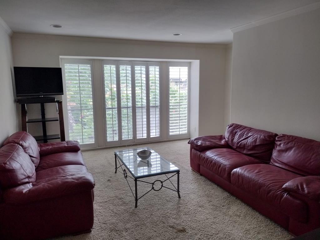 4563 North O'Connor Road, Unit 2298 Irving, TX 75062 - Photo 5 of 12 a living room with furniture a flat screen tv and a large window