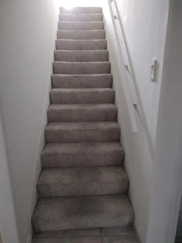 a bed sitting in a bedroom and dresser