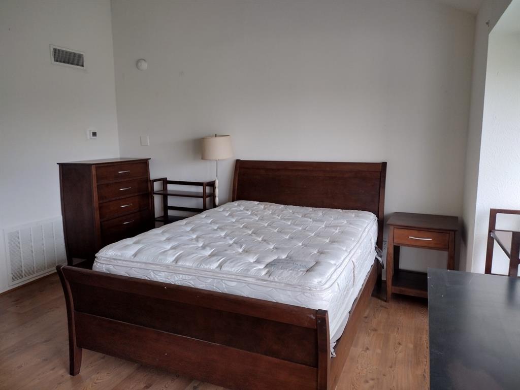4563 North O'Connor Road, Unit 2298 Irving, TX 75062 - Photo 7 of 12 a bed sitting in a bedroom and dresser
