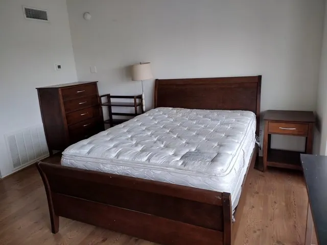 a bedroom with a bed and a view of chair