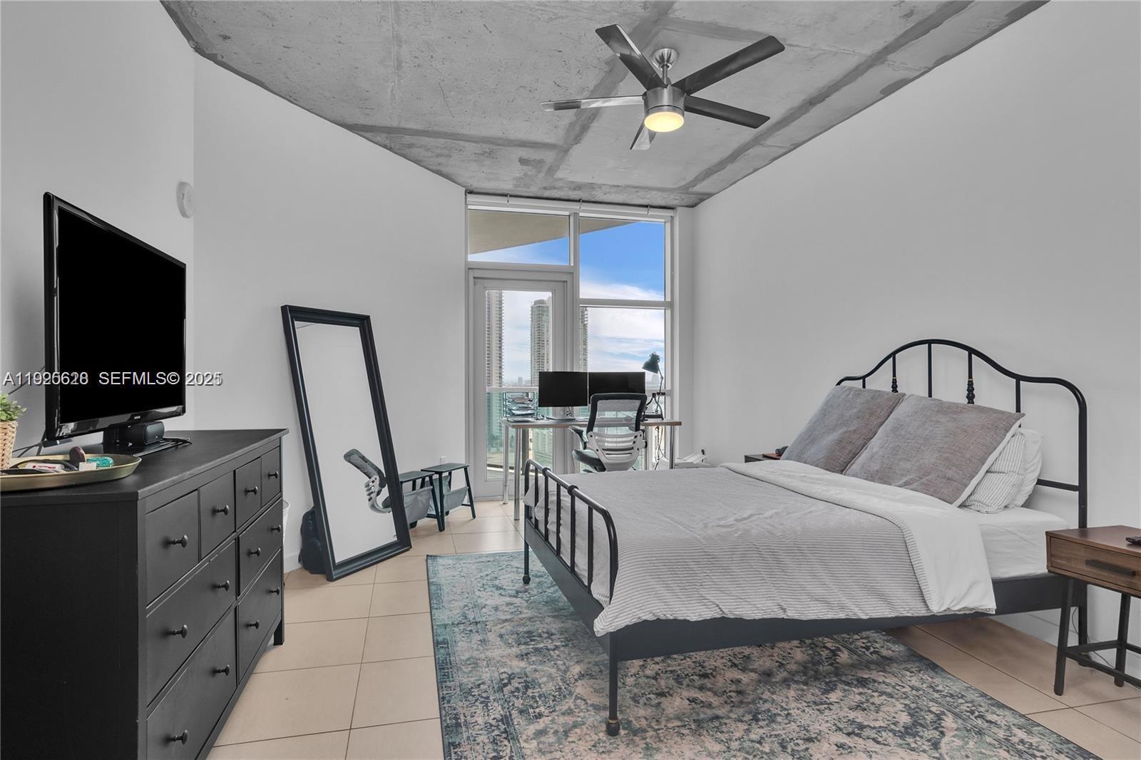 3301 Northeast 1st Avenue, Unit H2606 Miami, FL 33137 - Photo 19 of 31 a bedroom with a bed and a flat screen tv