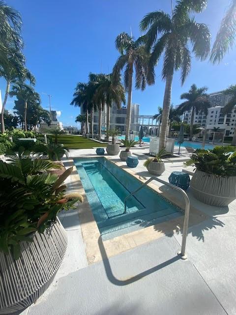 3301 Northeast 1st Avenue, Unit H2606 Miami, FL 33137 - Photo 22 of 31 a view of swimming pool with lounge chair and palm tree