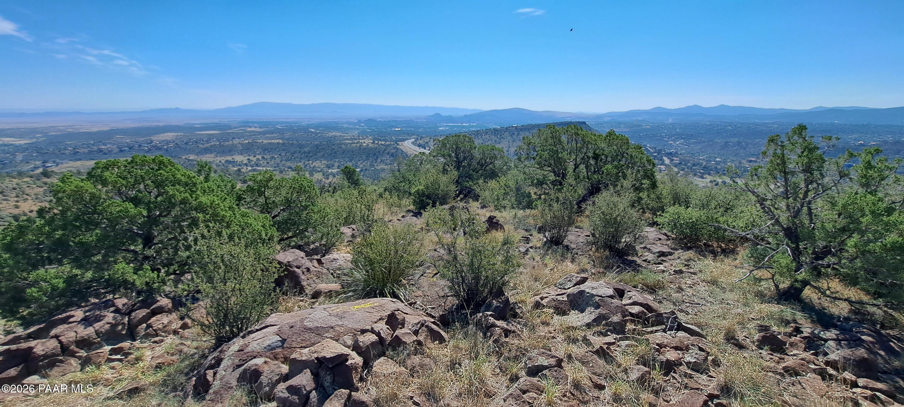 a view of a big yard with mountains in the background