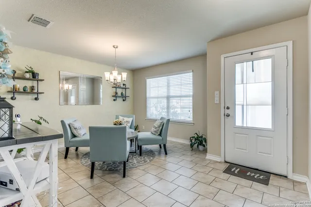 a view of a dining room with furniture and chandelier