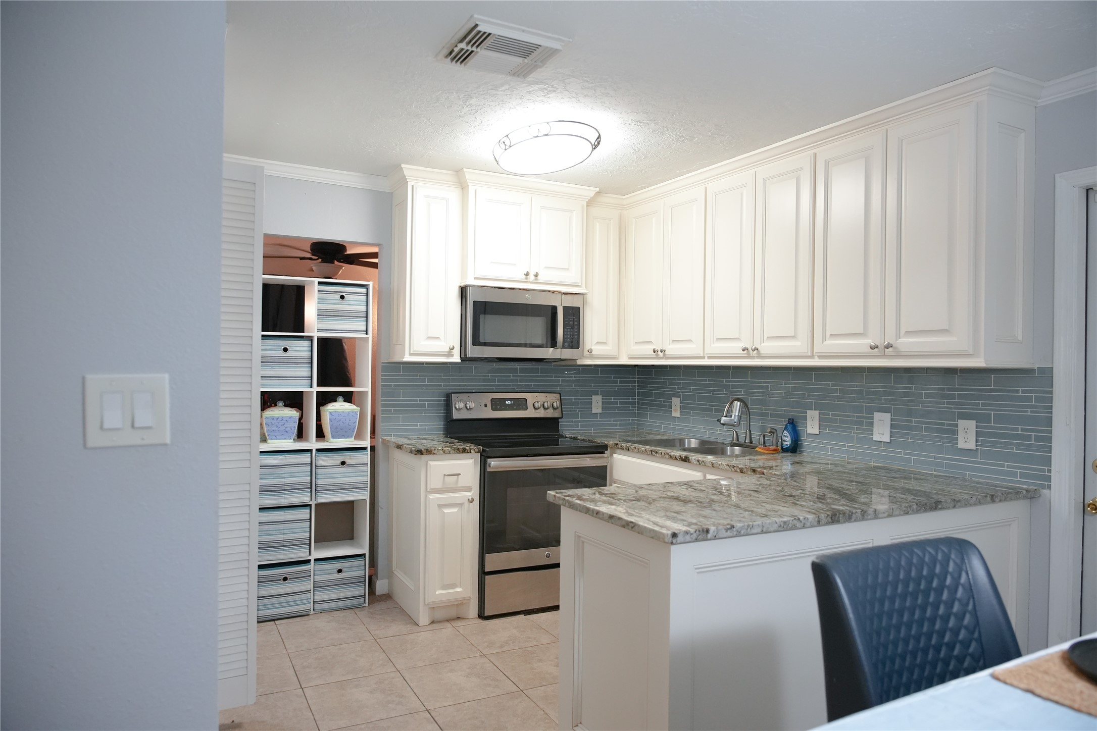 2117 Pecan Street Dickinson, TX 77539 - Photo 7 of 12 a kitchen with stainless steel appliances granite countertop a stove top oven a sink and dishwasher