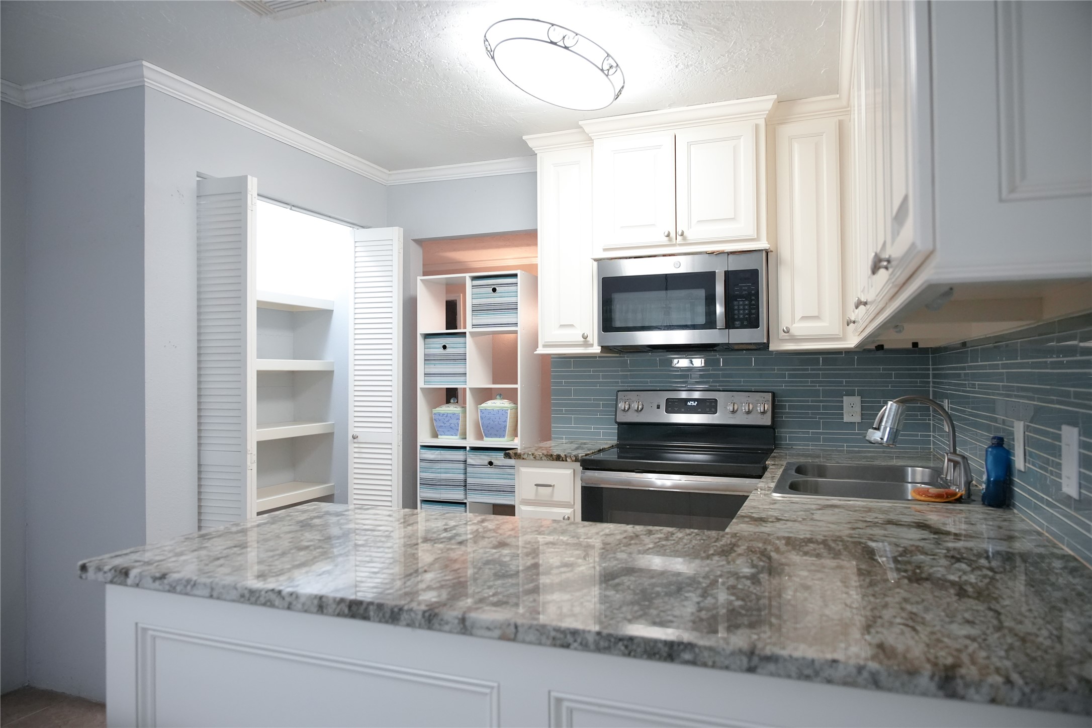 2117 Pecan Street Dickinson, TX 77539 - Photo 8 of 12 a kitchen with granite countertop a stove oven and a sink