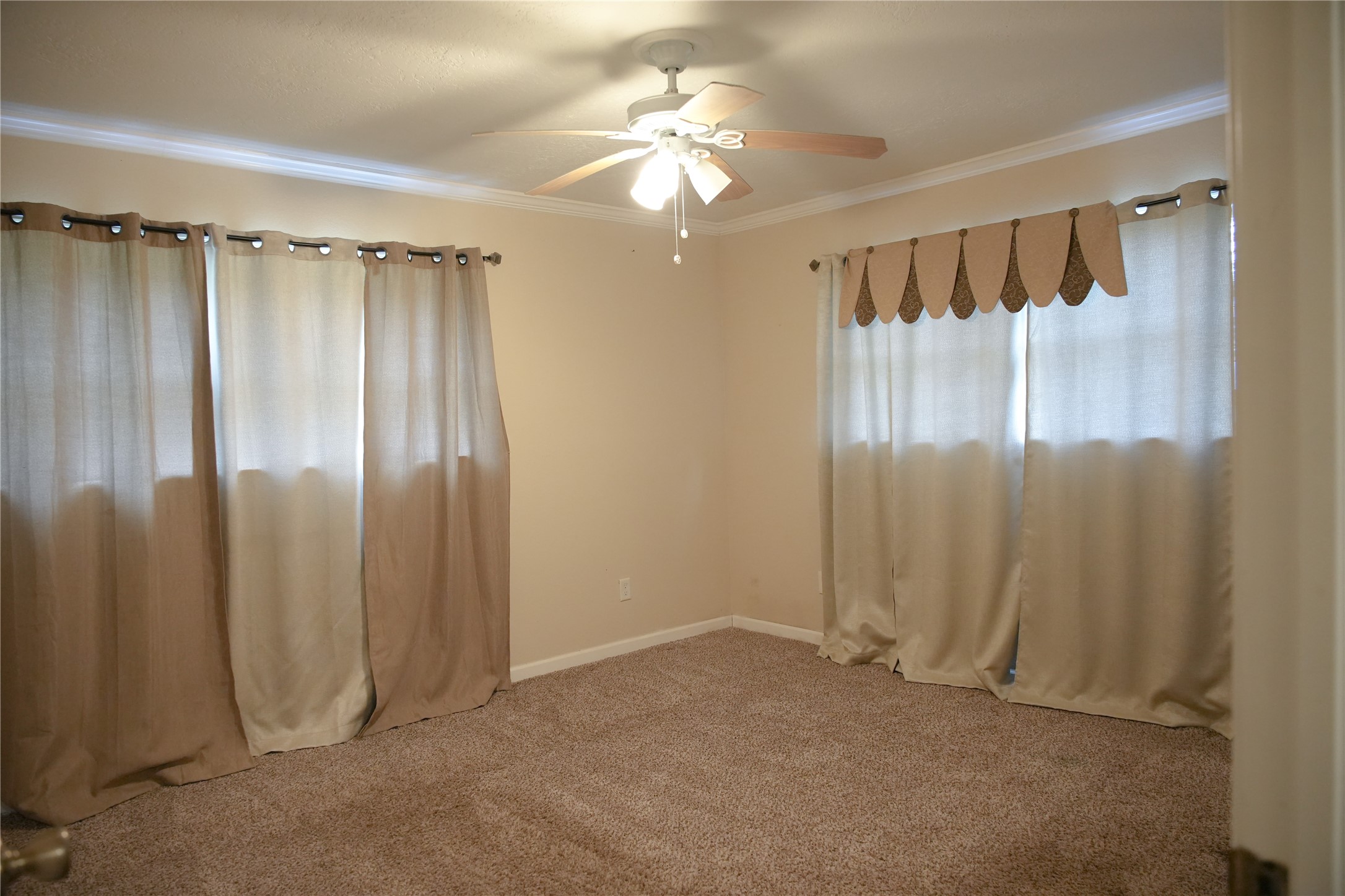 2117 Pecan Street Dickinson, TX 77539 - Photo 10 of 12 a view of a room with a glass door and a chandelier fan
