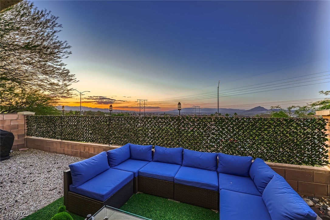 672 Solitude Point Avenue Henderson, NV 89012 - Photo 23 of 27 Patio terrace at dusk with an outdoor living space