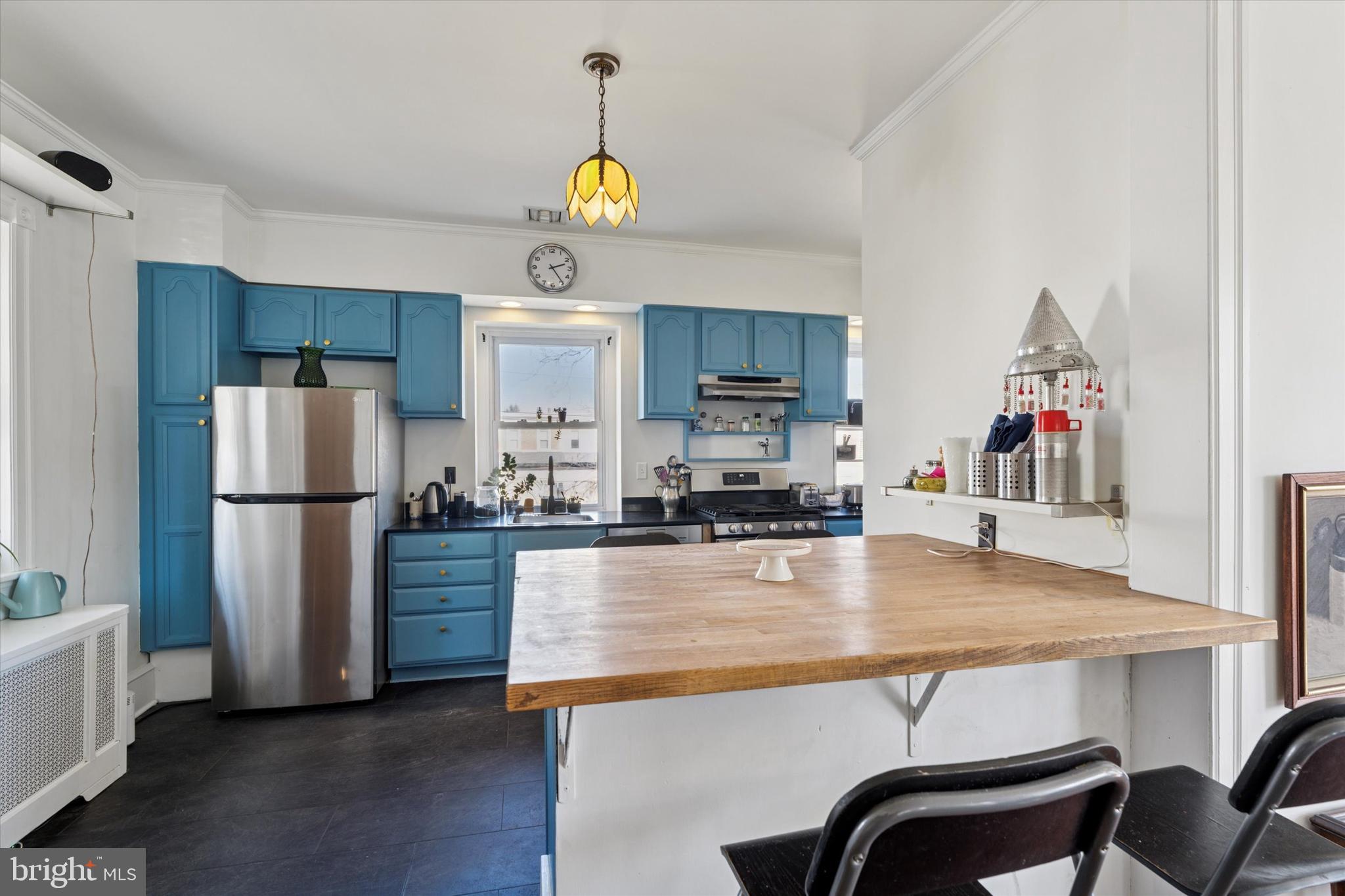 305 Grayling Avenue Narberth, PA 19072 - Photo 15 of 40 a kitchen with stainless steel appliances a dining table a stove top oven a sink and a refrigerator