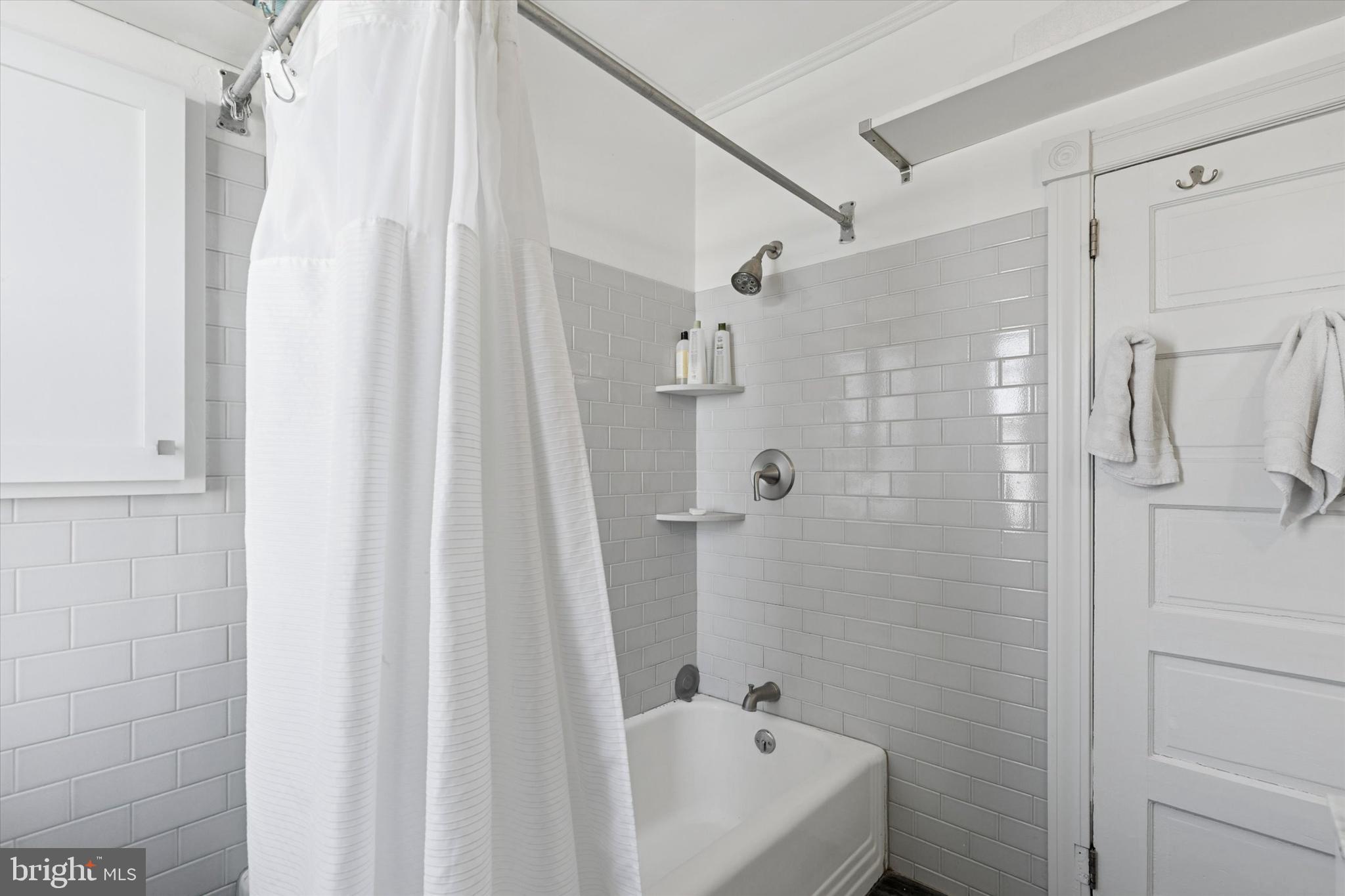305 Grayling Avenue Narberth, PA 19072 - Photo 21 of 40 a bathroom with a tub shower vanity and a sink